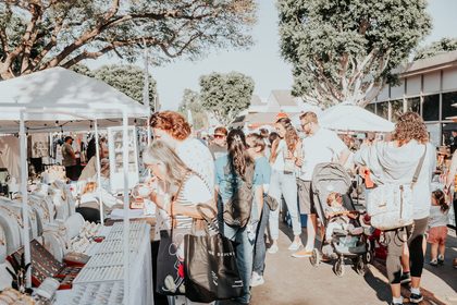 Families browsing vendor booths at a Dreamers Markets pop-up